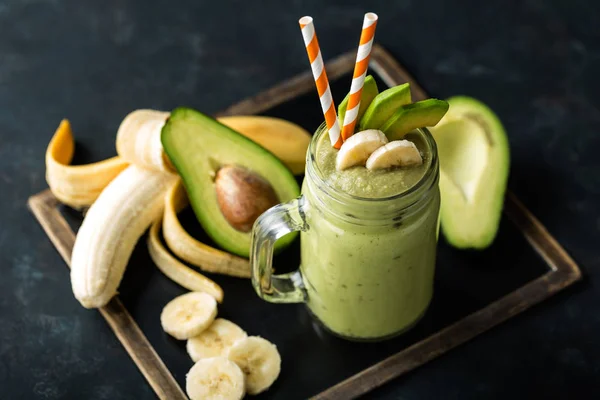 Batido de plátano y aguacate recién mezclado con yogur o leche en tarro de albañil, alimentación saludable —  Fotos de Stock