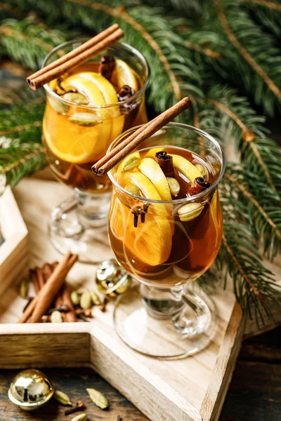 Grog. Hot drink for the winter holidays of the New Year and Christmas. Spicy tea and rum cocktail with lemon, cardamom, cinnamon and cloves.