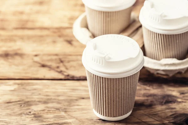 Coffee or tea in a paper cup with a lid