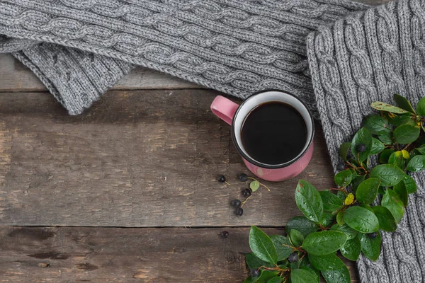 ahşap bir masa üzerinde gri bir Fularlı pembe kupa