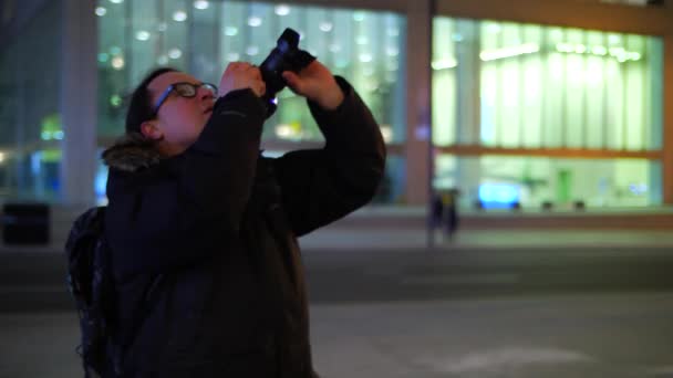 Male Photographer Taking Photo Tall Downtown Office Buildings Night — Stock Video