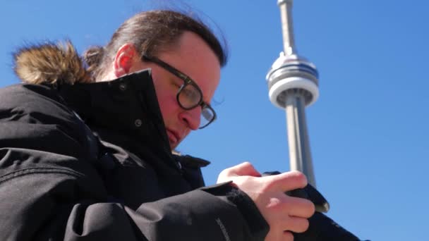 男性カメラマンの背景にある タワーの写真 — ストック動画