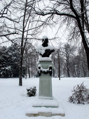 Bir parkta karla kaplı heykel