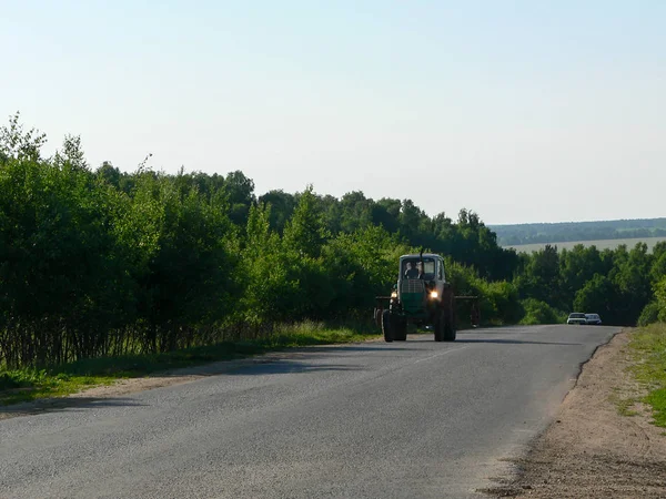 Tractor on a country road in Russia — Stock Photo, Image