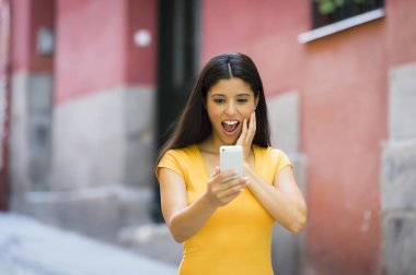 Shocked woman holding smartphone 