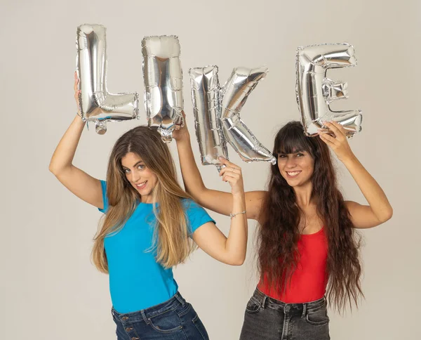 Två Vackra Unga Kvinnor Som Håller Ballonger Som Text Glad — Stockfoto