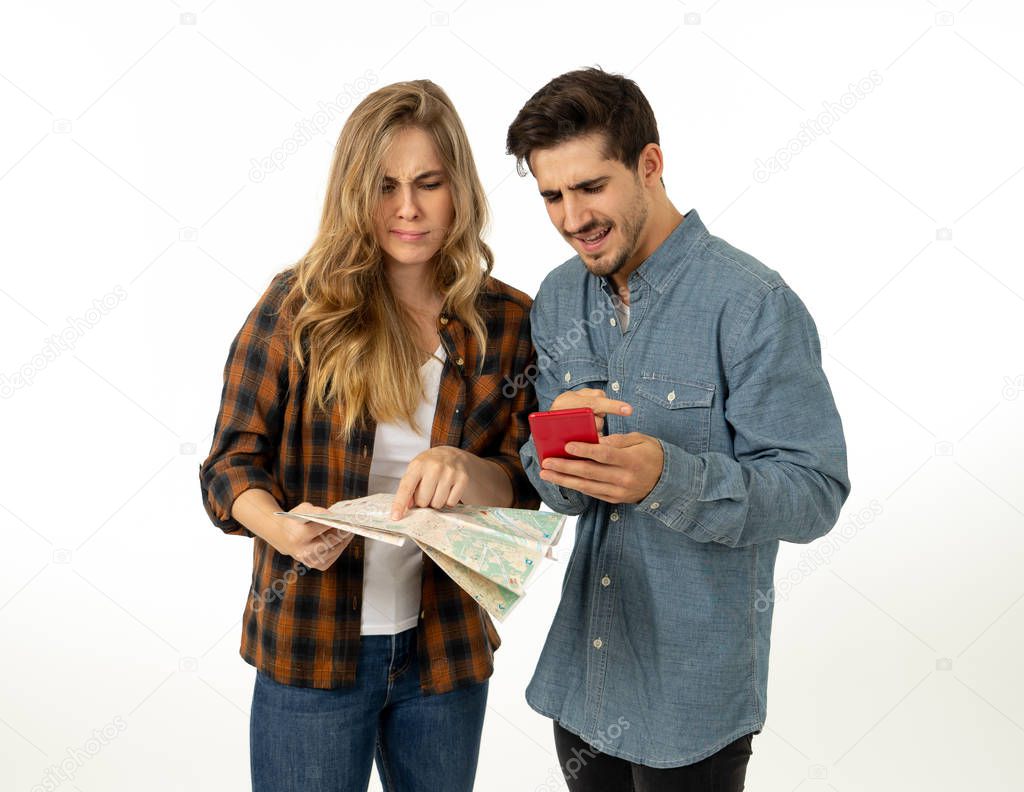Young tourist couple consulting a city guide map and smart phone gps searching for locations looking lost and confused. Travel industry and online app advertising style image isolated on white.