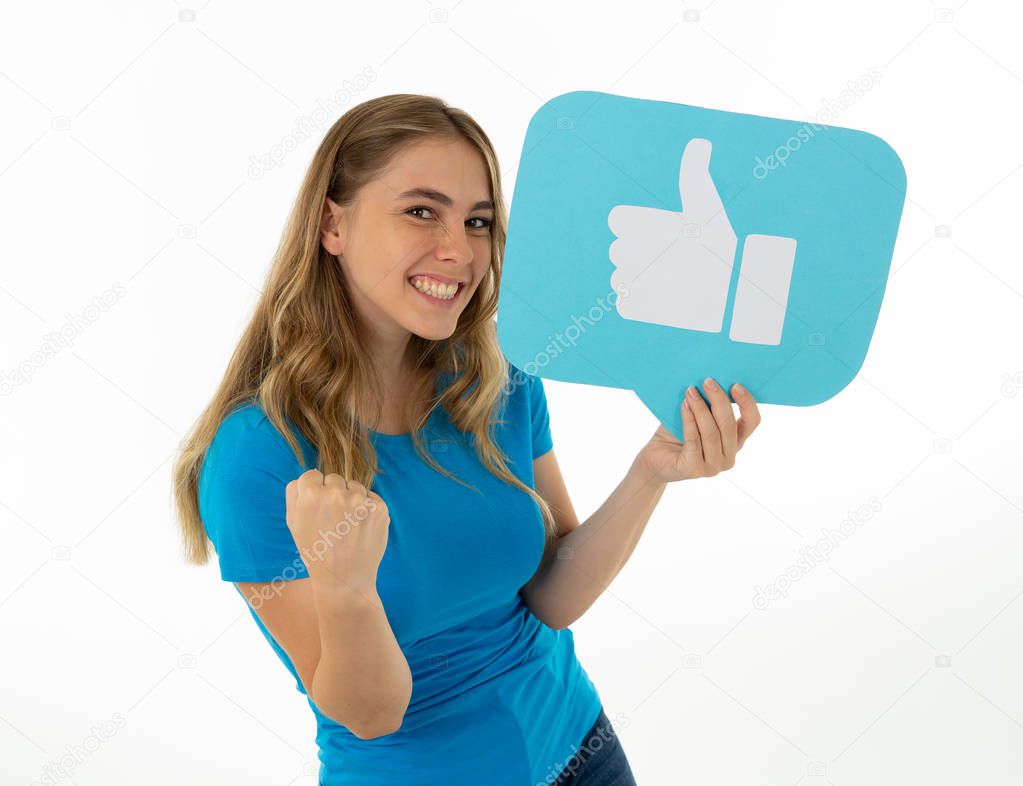 Beautiful young woman holding Like symbol social media notification icon asking followers to like her online comments, blog or business. In Internet obsession, networking and technology connections.