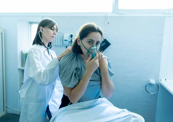 Egy Fiatal Beteg Oxigénmaszkot Visel Míg Női Orvos Sztetoszkóppal Hallgatja — Stock Fotó