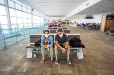 Coronavirus outbreak travel restrictions. Travelers with face mask at international airport affected by flights cancellations and travel ban. COVID-19 pandemic worldwide border closures and shutdowns. clipart
