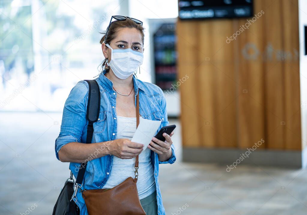 Coronavirus outbreak travel restrictions. Travelers with face mask at international airport affected by flights cancellations and travel ban. COVID-19 pandemic worldwide border closures and shutdowns.