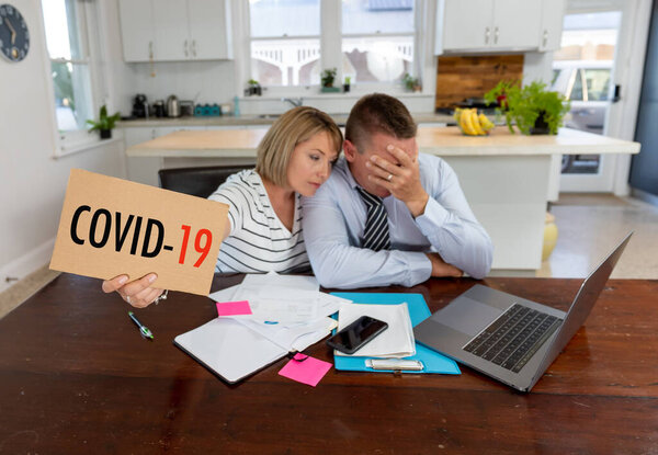 Coronavirus economic recession. Family couple in distress of job losses worried about bills, credit debts, loans and home finances. Impact of COVID-19 pandemic shutdowns and global economy crisis.