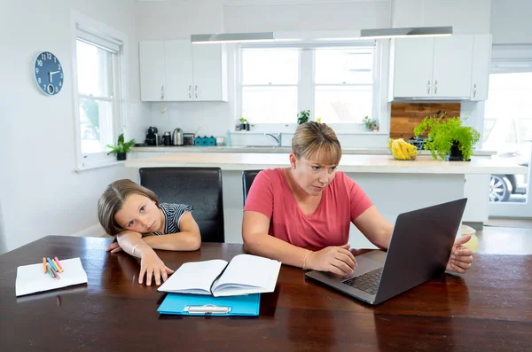 Coronavirus Outbreak schools and offices closing. Stressed mother coping with remote work and bored daughter. COVID-19 shutdowns and quarantines forces parents to work from home and homeschooling.