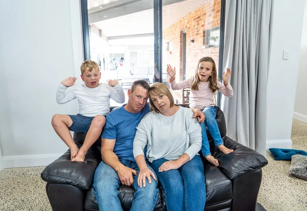 Stressed out parents struggling with having the children at home during Coronavirus self-isolation. Mother and father trying to cope with anxious kids during quarantine. COVID-19 Health crisis impact.