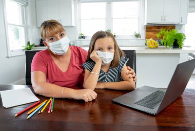 Coronavirus Outbreak. Lockdown and school closures. Mother helping bored daughter with face mask studying online classes at home. COVID-19 pandemic forces children and teachers online learning. clipart