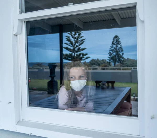 Covid Lockdown Depressed Lonely Little Girl Face Mask Looking Window — Stock Photo, Image