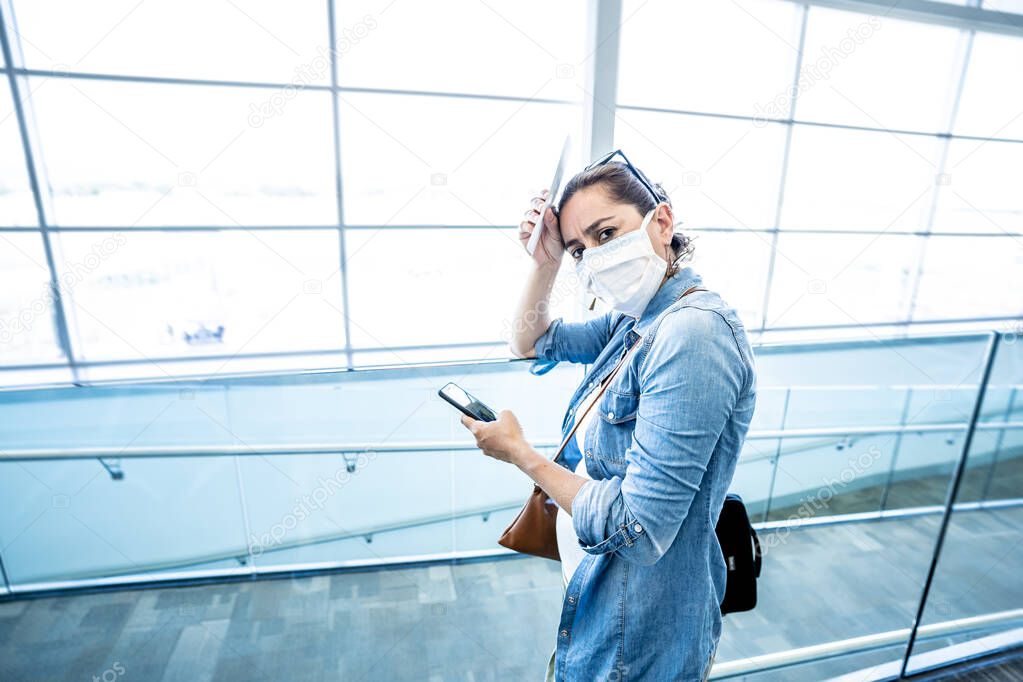 COVID-19 worldwide borders closures.Traveler with face mask stuck in airport terminal after being denied entry to other countries. Passenger stranded in airport on his travel back to home country.