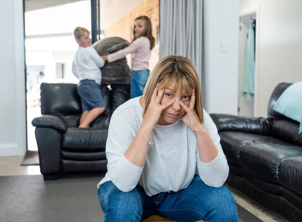 COVID-19 Isolation and mental health. Stressed out parents struggling with having the children at home during Coronavirus lockdown. Overwhelmed mother coping with anxious kids fighting in quarantine.