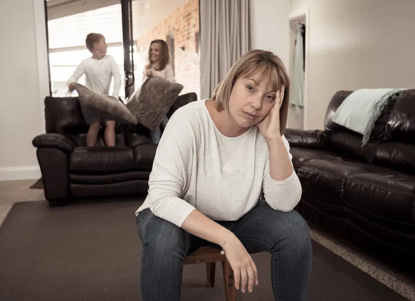 COVID-19 Isolation and mental health. Stressed out parents struggling with having the children at home during Coronavirus lockdown. Overwhelmed mother coping with anxious kids fighting in quarantine.