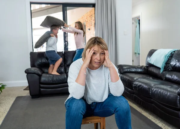 COVID-19 Isolation and mental health. Stressed out parents struggling with having the children at home during Coronavirus lockdown. Overwhelmed mother coping with anxious kids fighting in quarantine.