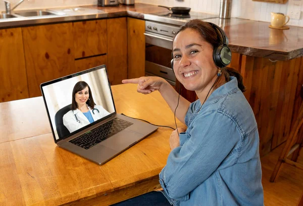 COVID-19 Online medical consultation. Woman in virtual appointment with online female doctor getting health advice and medical care from home in Coronavirus pandemic lockdown and social distancing.