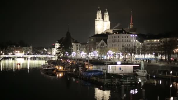 夜のヨーロッパの都市の時間の経過 川とスイスのチューリッヒに塔の間の橋 — ストック動画