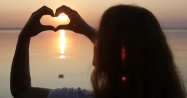 Red sun in the hands of a young woman.