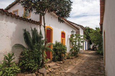 Eski renkli evleri ve Paraty bitki örtüsü ile Arnavut kaldırımlı sokak görünümü
