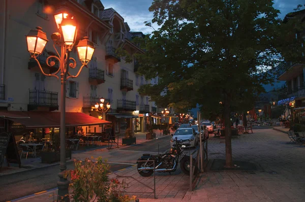 Straßenansicht in der Abenddämmerung im Stadtzentrum, mit Auto und Geschäften in Saint-Gervais-les-Bains. — Stockfoto