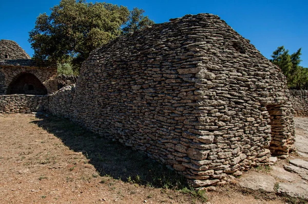 Tipikus hut kőből alatt napos kék ég, a Bories falu, közel a város Gordes. — Stock Fotó