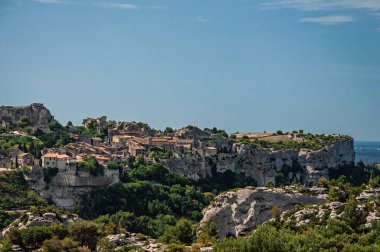 Köy ve cliff ve güneşli mavi gökyüzü üstüne Baux-de-Provence kalesinin panoramik manzaralı.
