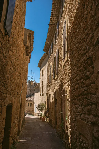 Vista de las típicas casas de piedra con cielo azul soleado, en un callejón elevado del histórico pueblo de Lourmarin . —  Fotos de Stock