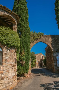 Taş duvar ve kemer girişinde Les Arcs-sur-Argens görünümü.