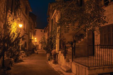 Night view of alley with walls and stone houses in the village of Vence. clipart