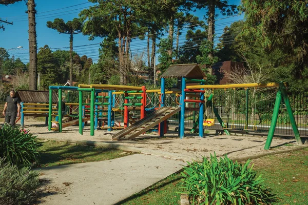 Colorful playground equipment and trees in Gramado — Stock Photo, Image