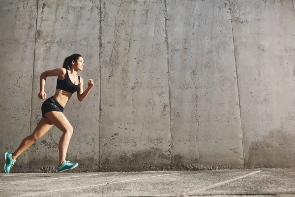 Starke Frau, die in ihrem Fitnessleben zum Erfolg rennt. Stadtsportkonzept. — Stockfoto