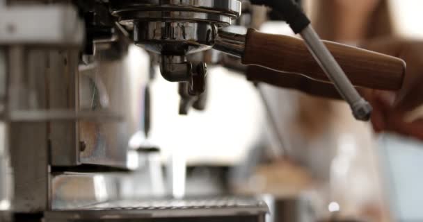 Barista preparing two espressos on coffee machine in busy cafe, skimming milk. Close up. Slow motion. — Stock Video