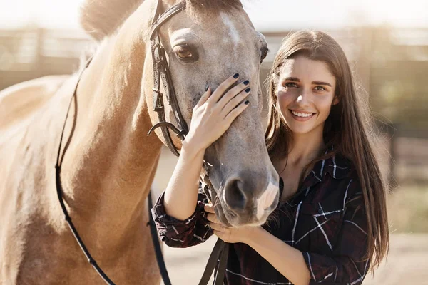 Portrait of beautiful woman petting a horse on animal farm or ranch dreaming to become a forage supplier. — Stock Photo, Image