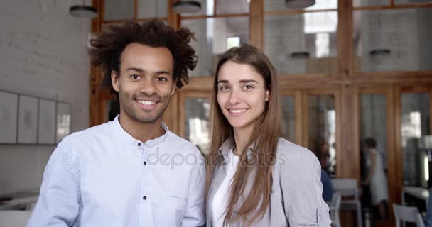 Portret mieszane pary studentów lub współpracowników w biurze otworzyć środowisko miejsca, patrząc na kamery, uśmiecha się i śmieje się. Udane pojęcie przedsiębiorczości i młodzieży. — Wideo stockowe