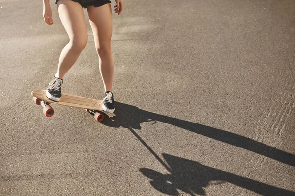 Skateboarding, Skatergirl-Konzept. abgeschnittene Frauenbeine, die auf Penny-Board stehen, Teenager üben Stunts, springen an Bord und versuchen einen neuen Stunt auf Betonskatepark-Straße durchzuführen — Stockfoto