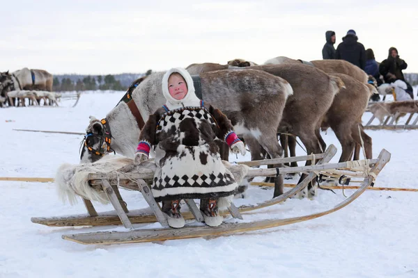 Fun Nenets girl in fur clothes with a national ornament on the b — Stock Photo, Image