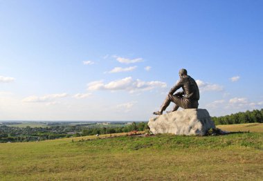 View of the monument to Vasily Shukshin and the village of Srost clipart