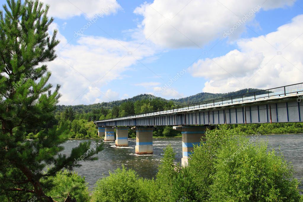 Bridge over the Biya river on a Sunny summer day in the Altai mo