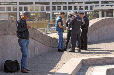 Moscow, RUSSIA-APRIL 30, 2017: police Officers on Europe square near the Kiev railway station check documents from Central Asians