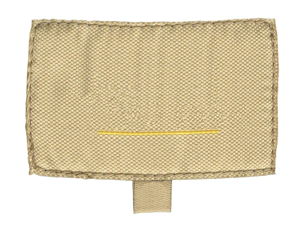 Vieja etiqueta de tela beige en blanco aislada en blanco —  Fotos de Stock