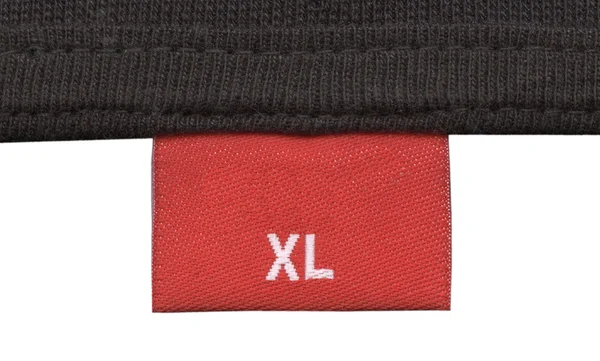 Fragment de tissu tricoté avec étiquette en tissu rouge — Photo