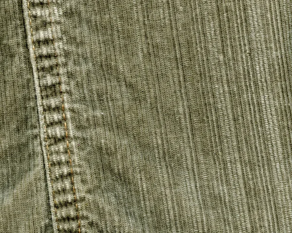 Fragment of green jeans, a seam — Stock Photo, Image