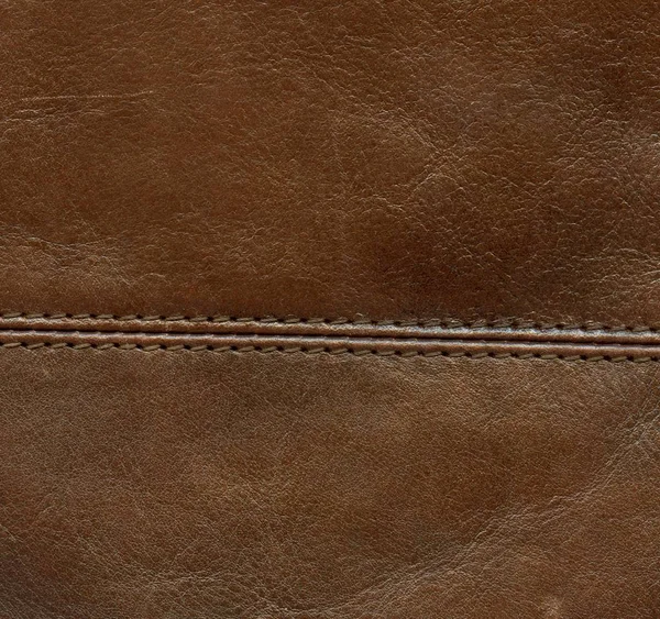 Brown leather background decorated with a seam — Stock Photo, Image