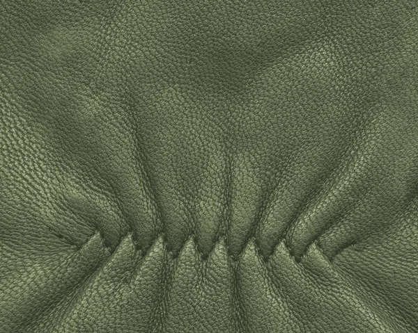 Green leather background, decorative seam — Stock Photo, Image