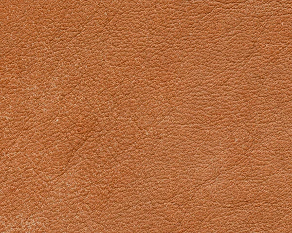Oranje lederen textuur close-up als achtergrond — Stockfoto